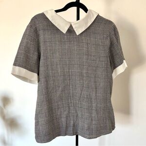 black/dark grey plaid shirt with white collar accents